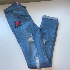 Light distressed jeans with embroidered roses